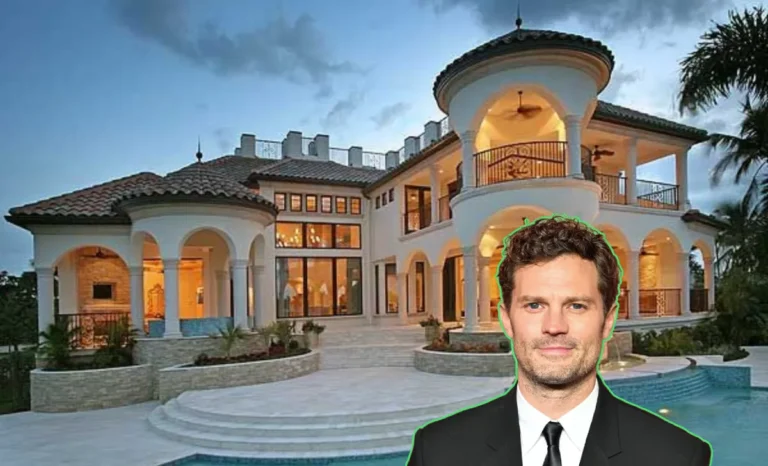 Exterior view of the Jamie Dornan House showing its mid-century modern design, glass atrium, and pool area.