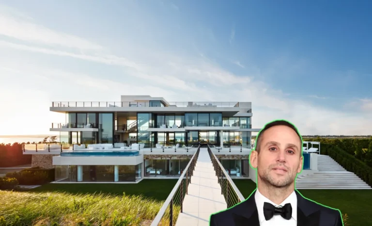 Aerial view of the Michael Rubin Hamptons House showing its oceanfront pool, modern white exterior, and glass walls.